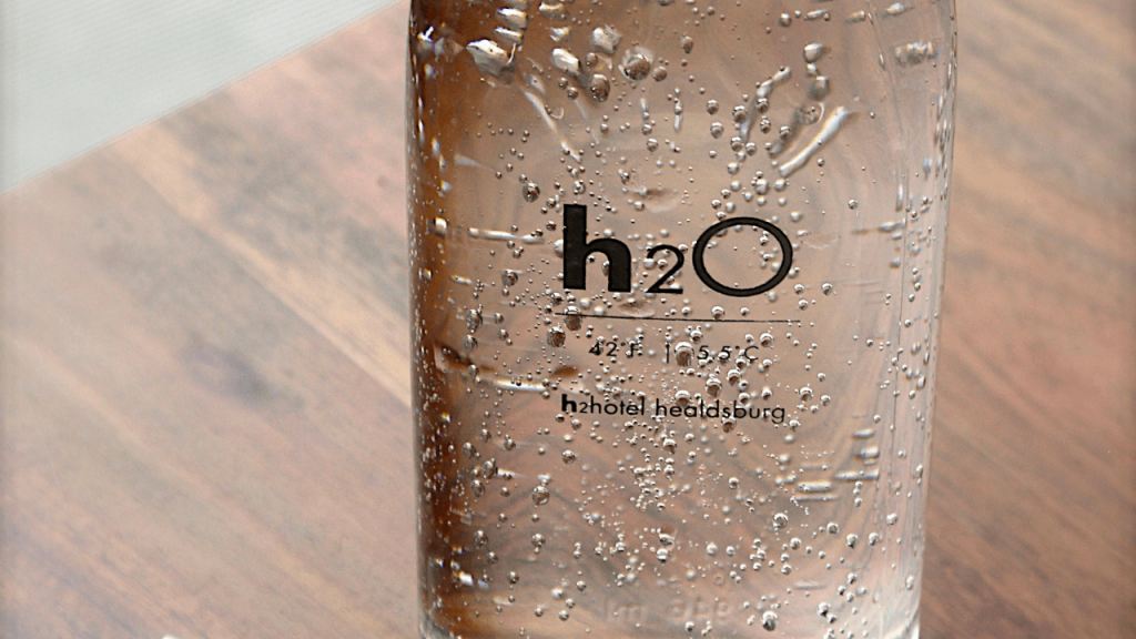 Close up shot of a water bottle. The bottle says h2o