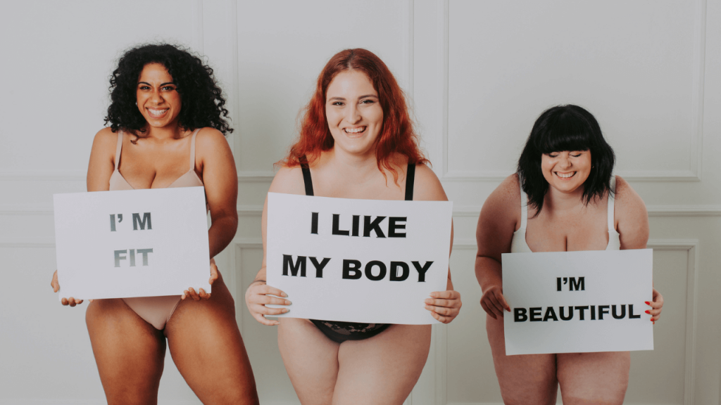 Multiple short curvy ladies with signs with positive body messages